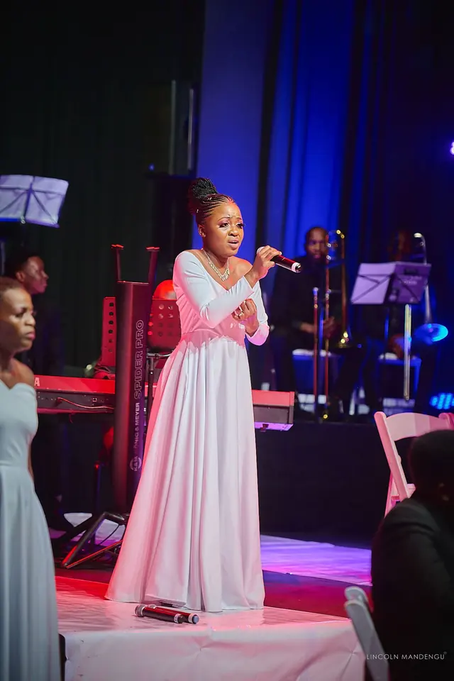A soloist sings with the band behind her