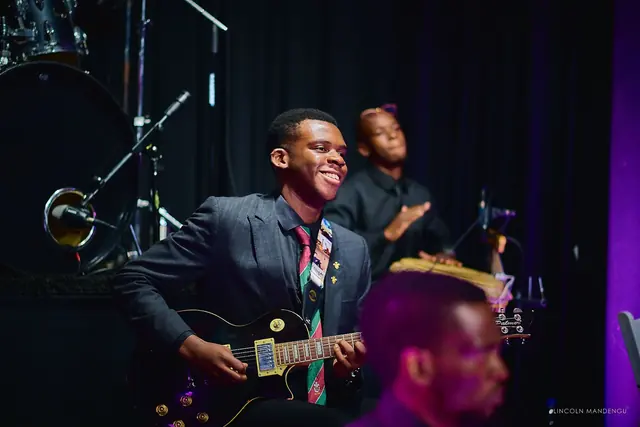 A guitarist and percussionist in the band