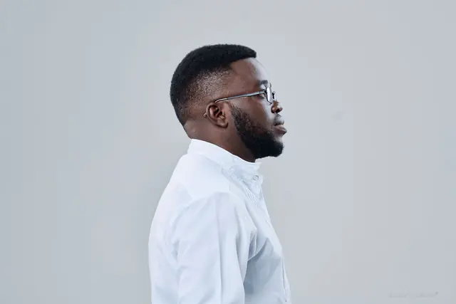 Tinashe Jera in profile, studio portrait