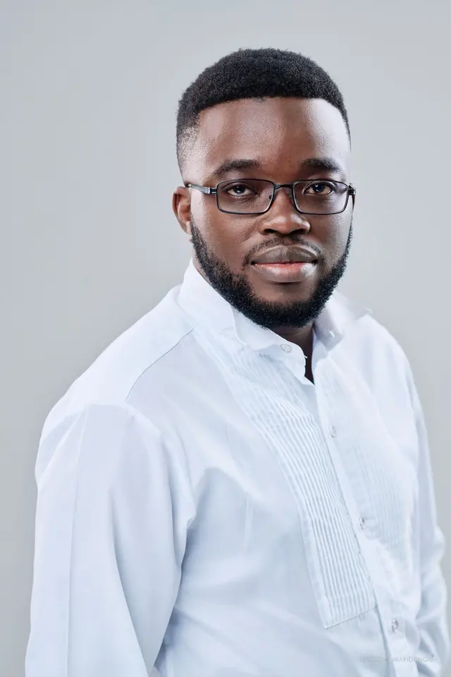 Tinashe Jera in a white shirt, studio portrait